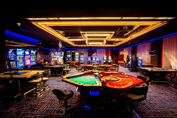 A player using their smartphone during a festive local event, representing 9777BED’s fully mobile-friendly casino.